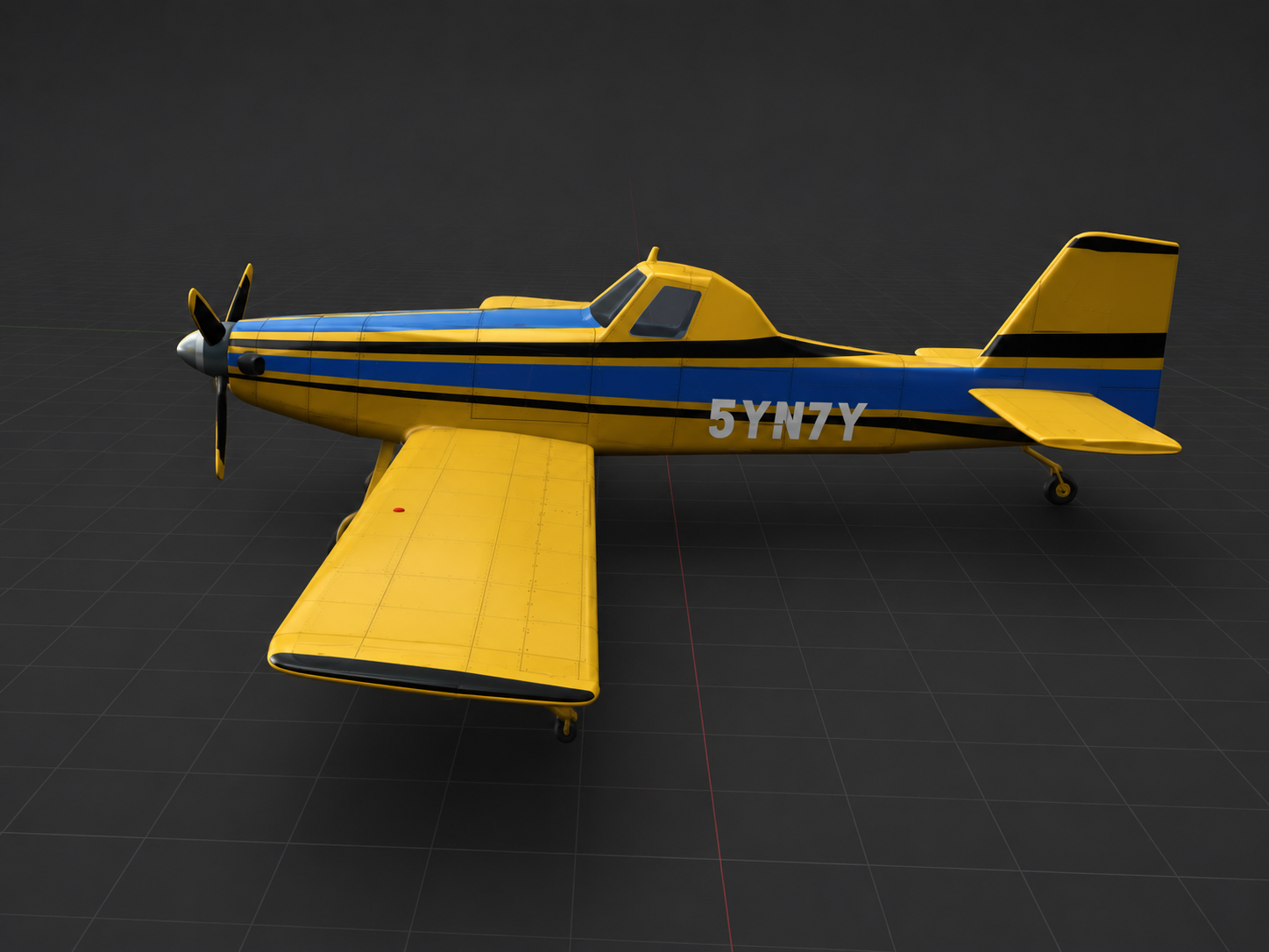 A yellow and blue aerobatic aircraft on a dark studio turntable